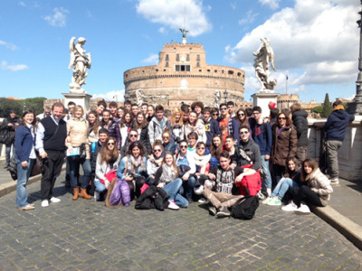 Group of people standing in front of a palace